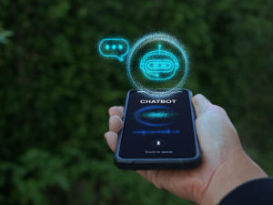 Digital chatbot, conversational agents, robot application, conversation assistant mimic human speech. Hand holding smartphone with chatterbot on virtual screen. AI Artificial Intelligence technology